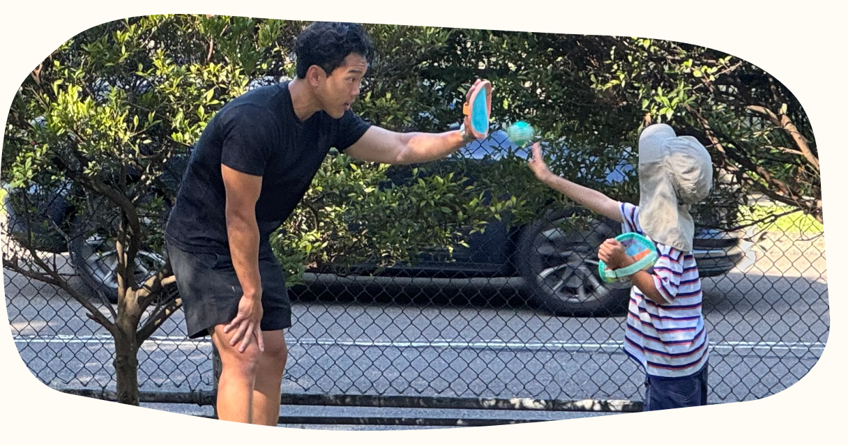 A child and clinician playing a catching game outdoors